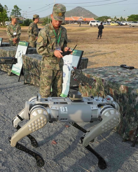 A Chinese soldier tests a robot dog before it’s equipped with a machine gun