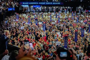 Donald Trump raises his fist to hundreds of supporters