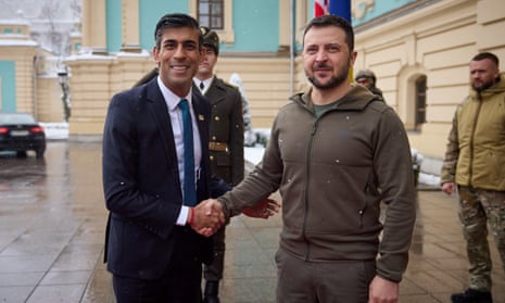 Zelenskiy shakes hands with Sunak in Kyiv.