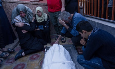 Palestinians mourn relatives killed in Israeli strikes at the hospital in Khan Younis, southern Gaza on Sunday.