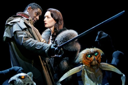 A woman looks to a man holding a sword