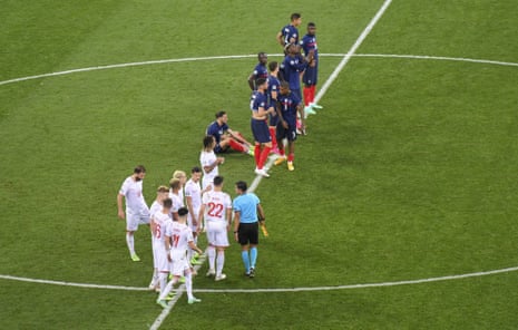 Swiss and French players gather at halfway as the penalty shoot out begins.