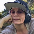 a woman wearing a hat, sunglasses and headphones
