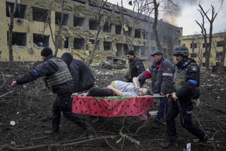 Emergency workers and volunteers carry an injured pregnant woman from a maternity hospital that was damaged by shelling in Mariupol. The baby was stillborn. Half an hour later, the mother died too.