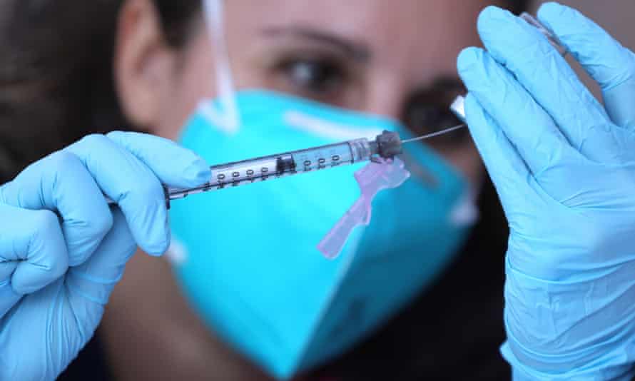 a nurse administers the Covid vaccine