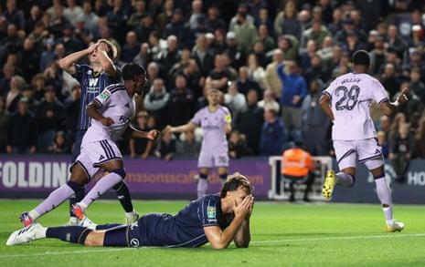 Newcastle United's Joe Willock (right) and teammates celebrates scoring their first goal as Millwall's Jake Cooper looks dejected.