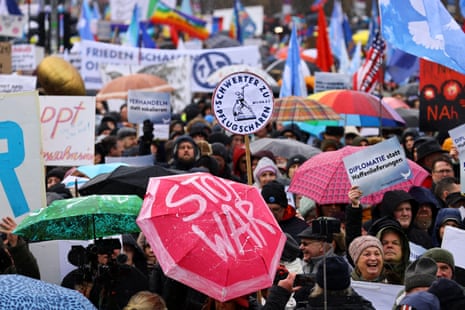 People take part in a protest against the delivery of weapons to Ukraine in Berlin, Germany.