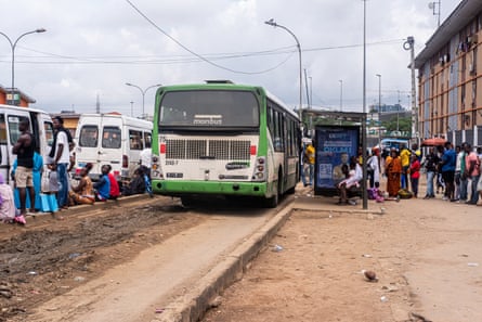 Passengers queueing for a bus in Abidjan.