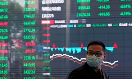 A man wearing a protective mask is seen inside the Shanghai stock exchange building, at the Pudong financial district in China
