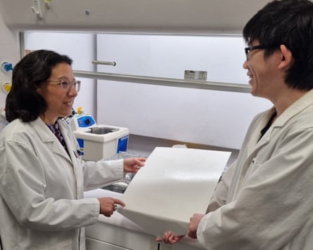 Prof Chiara Neto and Dr Ming Chiu with a panel of water-based cool roof paint applied on an aluminium panel