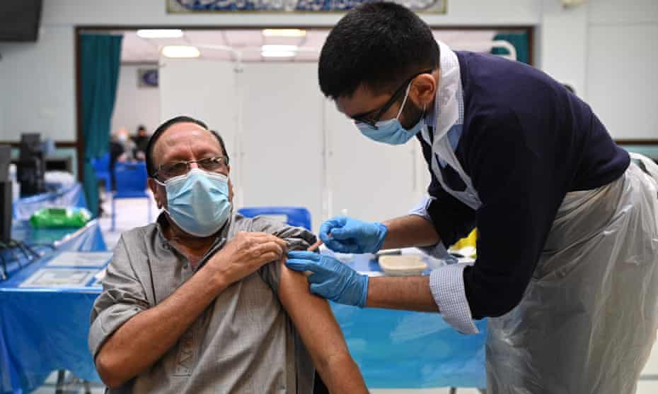 A pharmacist administers a dose of the Oxford/ AstraZeneca Covid vaccine at the Al-Abbas Islamic Centre in Birmingham.