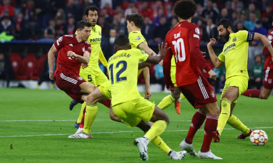 Bayern Munich’s Robert Lewandowski scores their first goal.