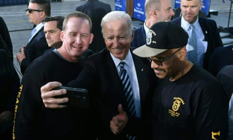 US-POLITICS-BIDEN-INFRASTRUCTURE<br>US President Joe Biden takes a selfie with workers during a visit at the Port of Baltimore in Baltimore, Maryland on November 10, 2021. - Biden is visiting on Wednesday the Port of Baltimore the 12th busiest port in the United States to promote his recently passed $1.2 trillion bipartisan infrastructure bill. (Photo by Brendan SMIALOWSKI / AFP) (Photo by BRENDAN SMIALOWSKI/AFP via Getty Images)