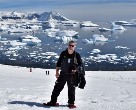 Martin Anstee standing on a snowy field in front of icebergs