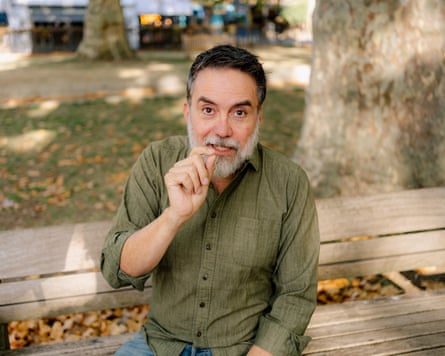 Arturo Bejar gestures, on a bench in a London square