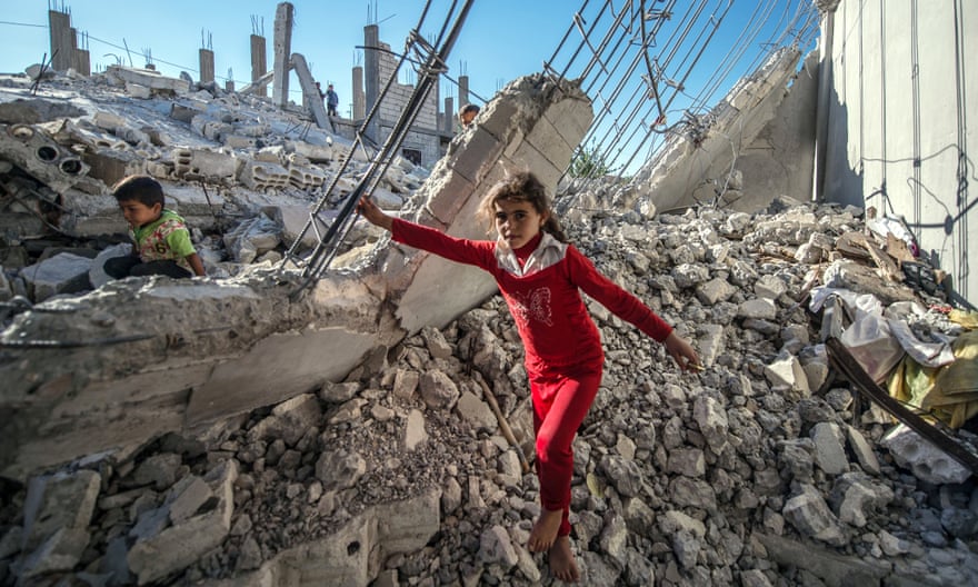 Children are seen on the rubble of a building in the Jarabulus district of Aleppo,.