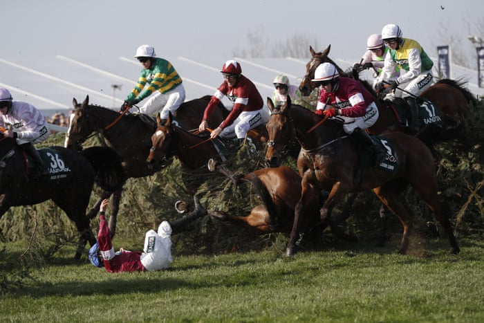 Davy Russell riding Tiger Roll (centre, maroon &amp; white cap) clears The Chair.