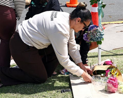 Members of the public lay tributes at the scene of a landslide triggered by heavy rains in Mount Maunganui, New Zealand.