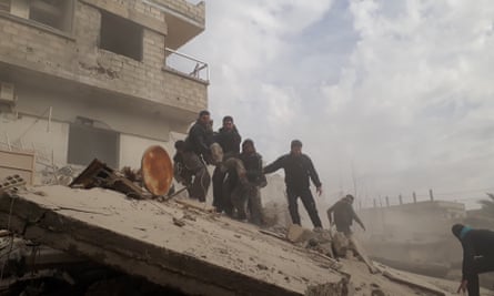 Civil defence workers carry a wounded man after airstrikes in East Ghouta, Damascus, 6 February.