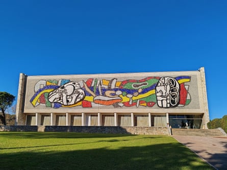 Street art-style mural on a modernist building.