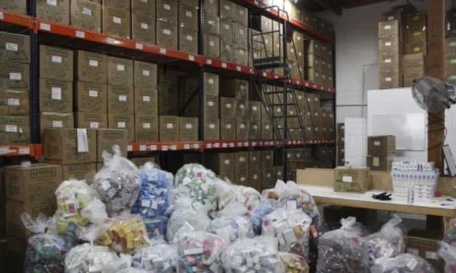 A warehouse is filled with boxes and bags of stolen items.