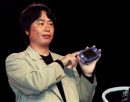 Legendary video game developer Shigeru Miyamoto holds up the new Nintendo Game Boy Advance in Los Angeles, May 2001.