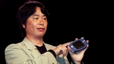 Video game developer Shigeru Miyamoto holds up the Nintendo Game Boy Advance during its launch in May 2001.