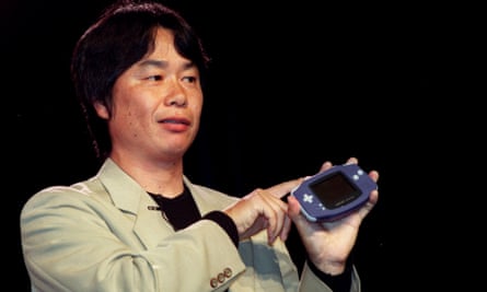 Video game developer Shigeru Miyamoto holds up the new Nintendo Game Boy Advance, 2001.