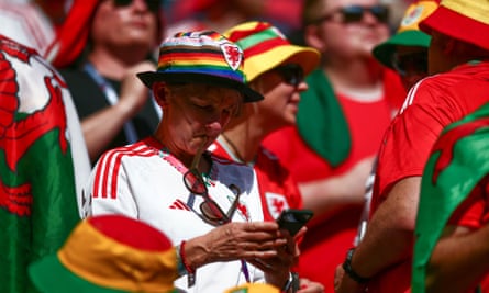 A Welsh fan wears a rainbow bucket hat to watch Wales v Iran in Qatar in November.