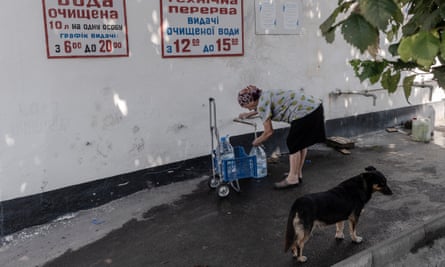 Residents of Mykolaiv collect water at the entrance of Mykolaiv Electotrans, which filters and delivers clean water using a special tram and trolleybuses.