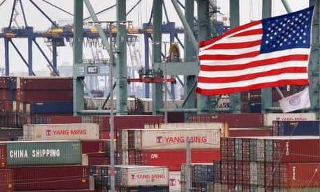 Chinese shipping containers near a US flag after they were unloaded at the Port of Los Angeles, California