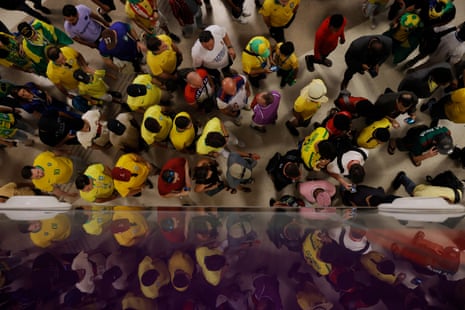 A crowd, mainly consisting of Brazil fans, make their way to a match at Stadium 974 on the gold line at Msheireb metro station where all three lines of the Doha metro system converge.