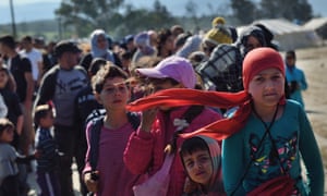 Refugees queue for food at the makeshift camp along the Greek-Macedonian border near the village of Idomeni