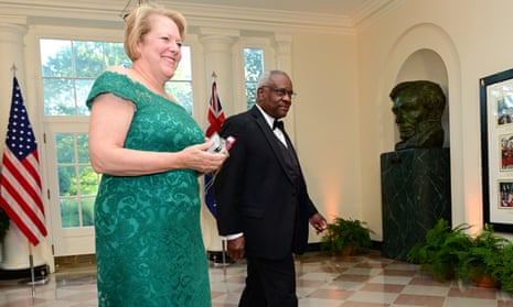 Ginni and Clarence Thomas walk through the White House in formal wear.