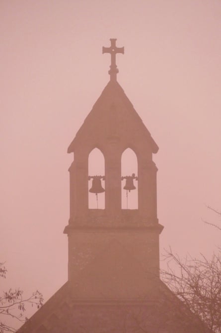 A church amid pink mist.