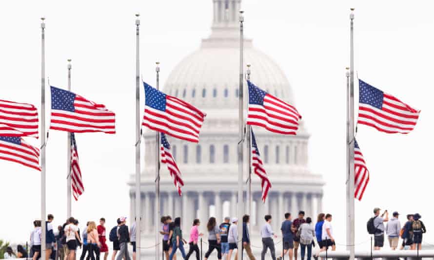 American flags fly at half-staff to mark one million deaths from the coronavirus on the National Mall in Washington