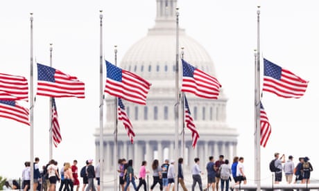 American flags fly at half-staff to mark one million deaths from the coronavirus on the National Mall in Washington DC, USA, on 12 May.