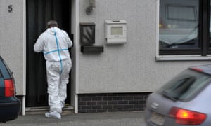A crime scene specialist enters a house in Wallenfels where the bodies of eight infants were discovered.