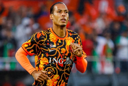 Van Dijk in orange and black top with prints of lions and chains