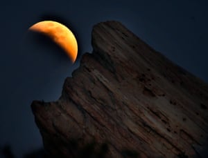 Vasquez Rocks National Park, US. The moon rises from the east three-quarters into the blood moon eclipse from Aqua Dulce in California