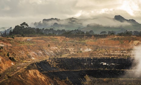 General view of the wall of a huge opencast mine sits right next to the township of Waihi, New Zealand.