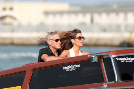 George and Amal Clooney on a boat in Venice