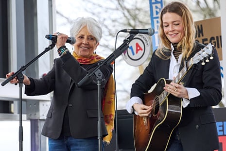 Singers Joan Baez, left, and Maggie Rogers perform during an “Artists United for our Freedoms” rally near the Kennedy Center, on Friday, 27 March 2026, in Washington.