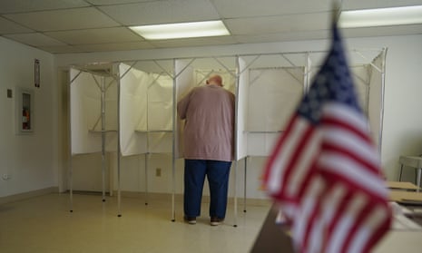 A man voting with American flag in foreground