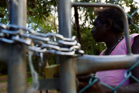 A Palumpa resident shows chains and locks at the centre