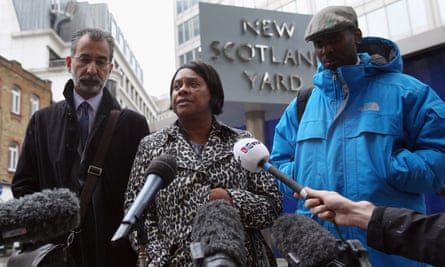Doreen Lawrence (C), the mother of Stephen Lawrence, addresses the media, with her son Stuart Lawrence (R) and the Lawrence family solicitor Imran Khan in 2013.