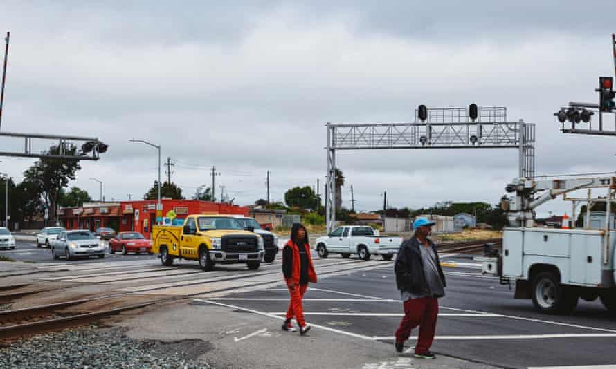 Pedestrians cross the railway lines that mark the border of the Iron Triangle neighbourhood of Richmond, which is known for its high crime rate.