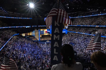 view of packed stadium from overhead, with a sign saying ‘kamala’ in the foreground