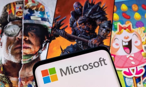 Microsoft logo on a smartphone placed on Activision Blizzard's games characters