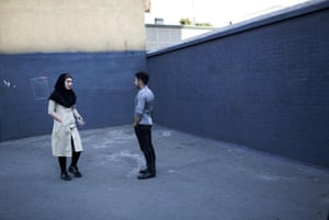 An Iranian couple chats on a street corner in downtown Tehran.